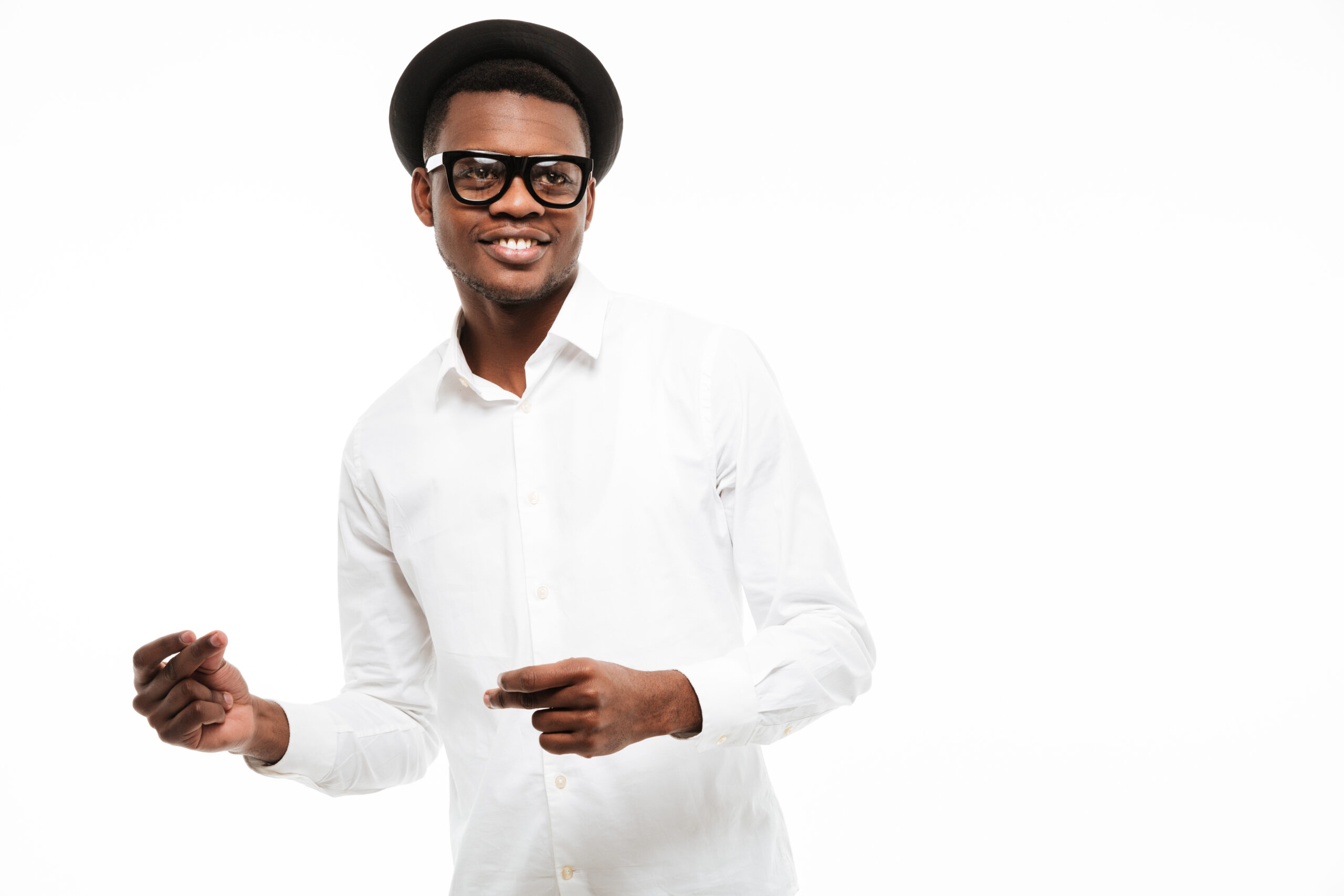Photo of happy young african man dressed in shirt wearing glasses isolated over white background. Looking aside.
